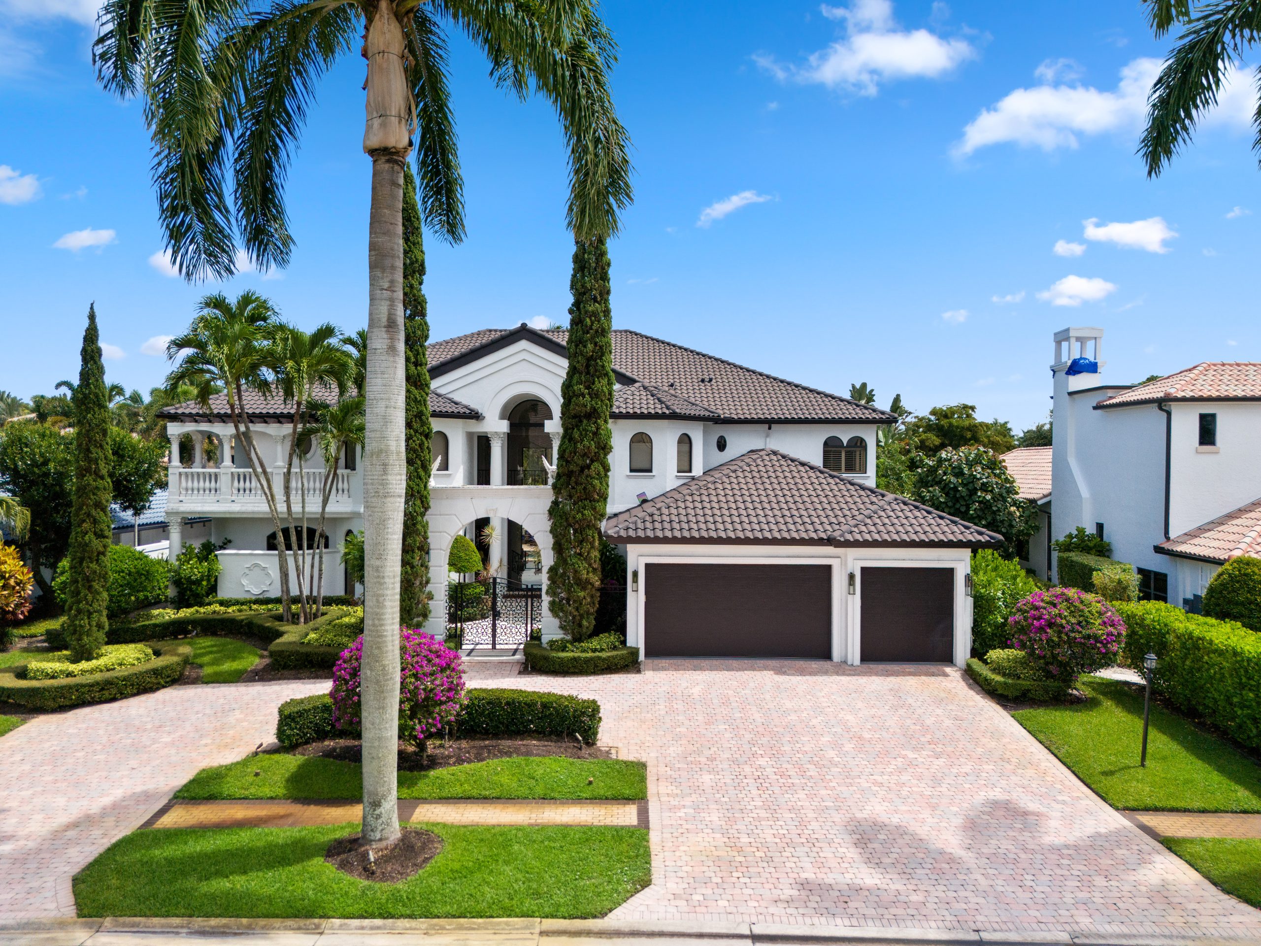 Front exterior photo of luxury lakefront estate in St. Andrews Country Club Boca Raton